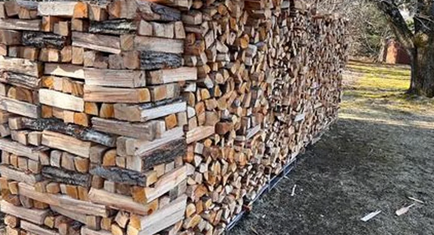 A real outdoor stack of split firewood used to illustrate the request-to-confirmation workflow.