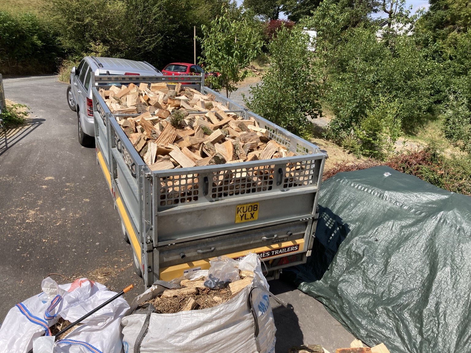 Live With Nature firewood loaded in a tipper trailer.